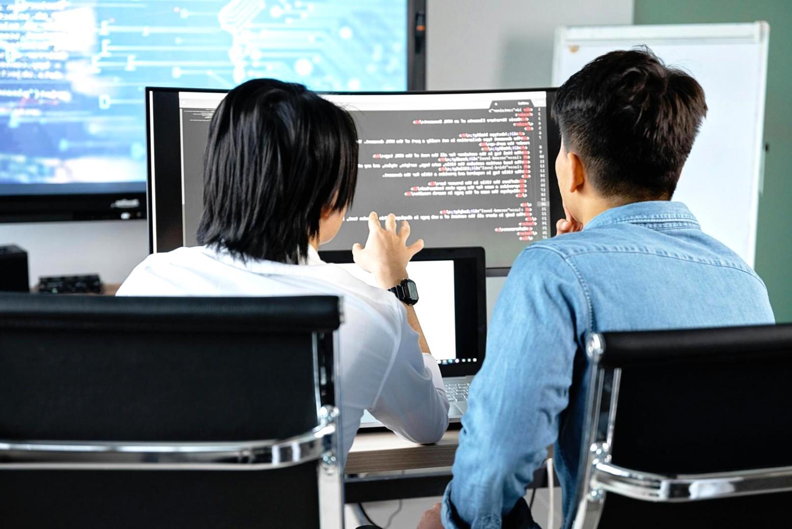 Advanced computer setup with machine learning model training progress displayed across multiple screens