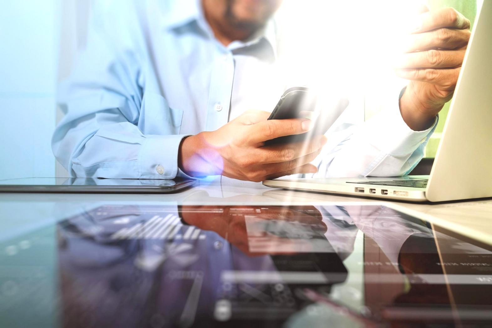 Modern workspace with multiple monitors displaying neural network visualization and data analysis dashboards